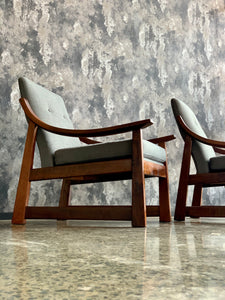 Pair of wooden armchairs with curved arms